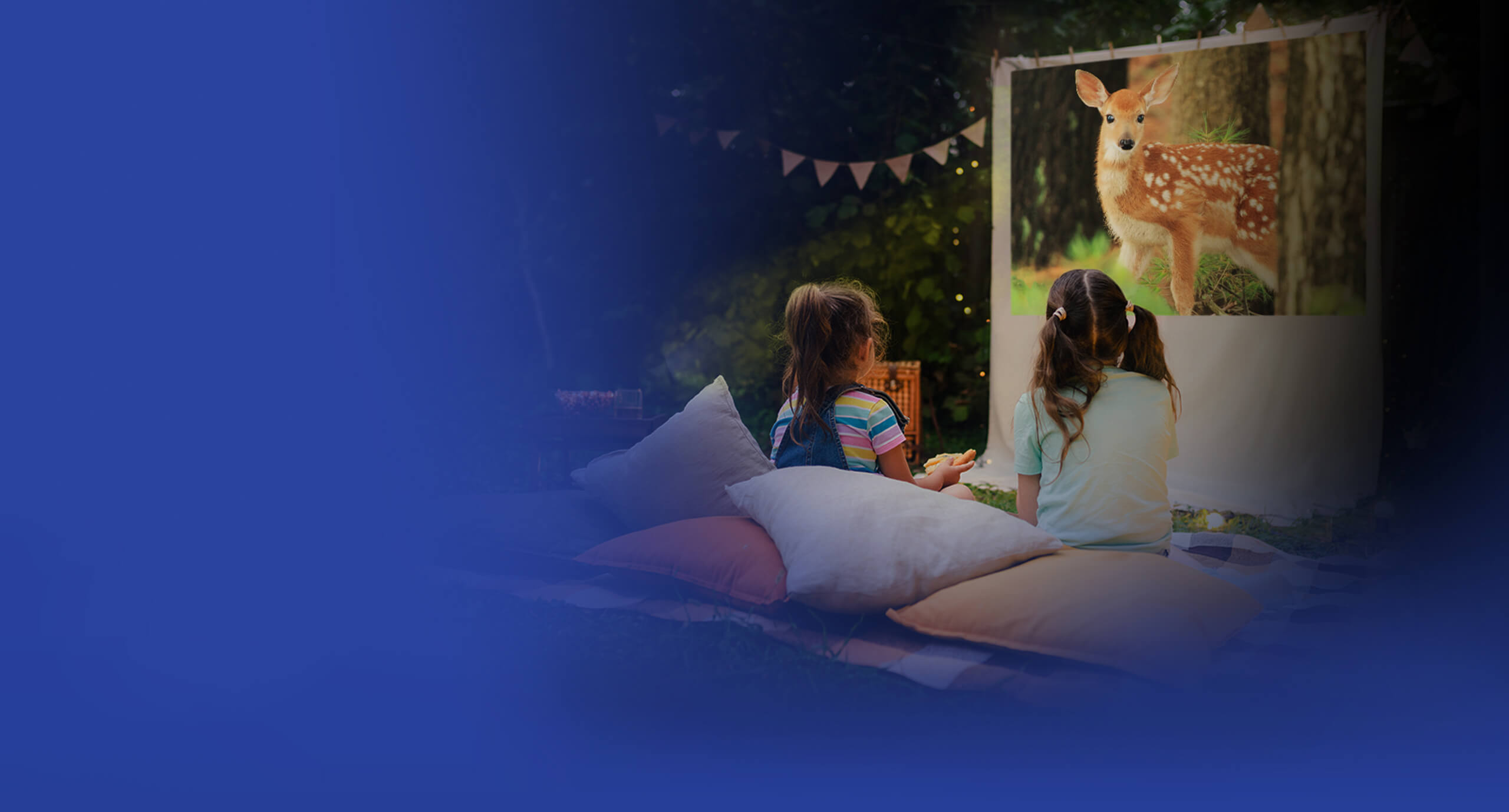 Jonge meisjes picknicken buiten en genieten van diergerelateerde filmcontent met de ASUS ZenBeam L2 slimme draagbare LED-projector