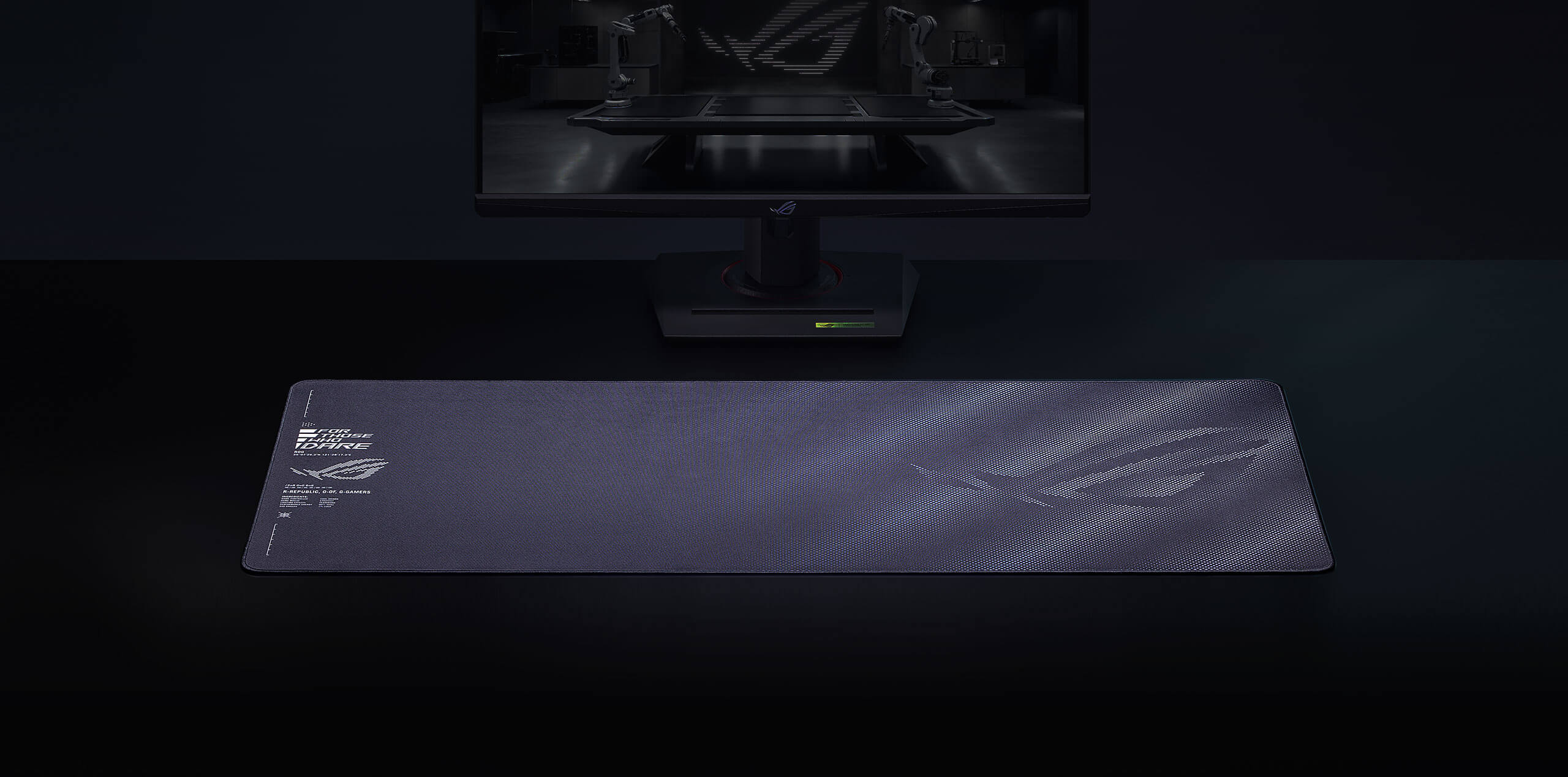 The black Sheath II XXL mouse pad set in front of a monitor