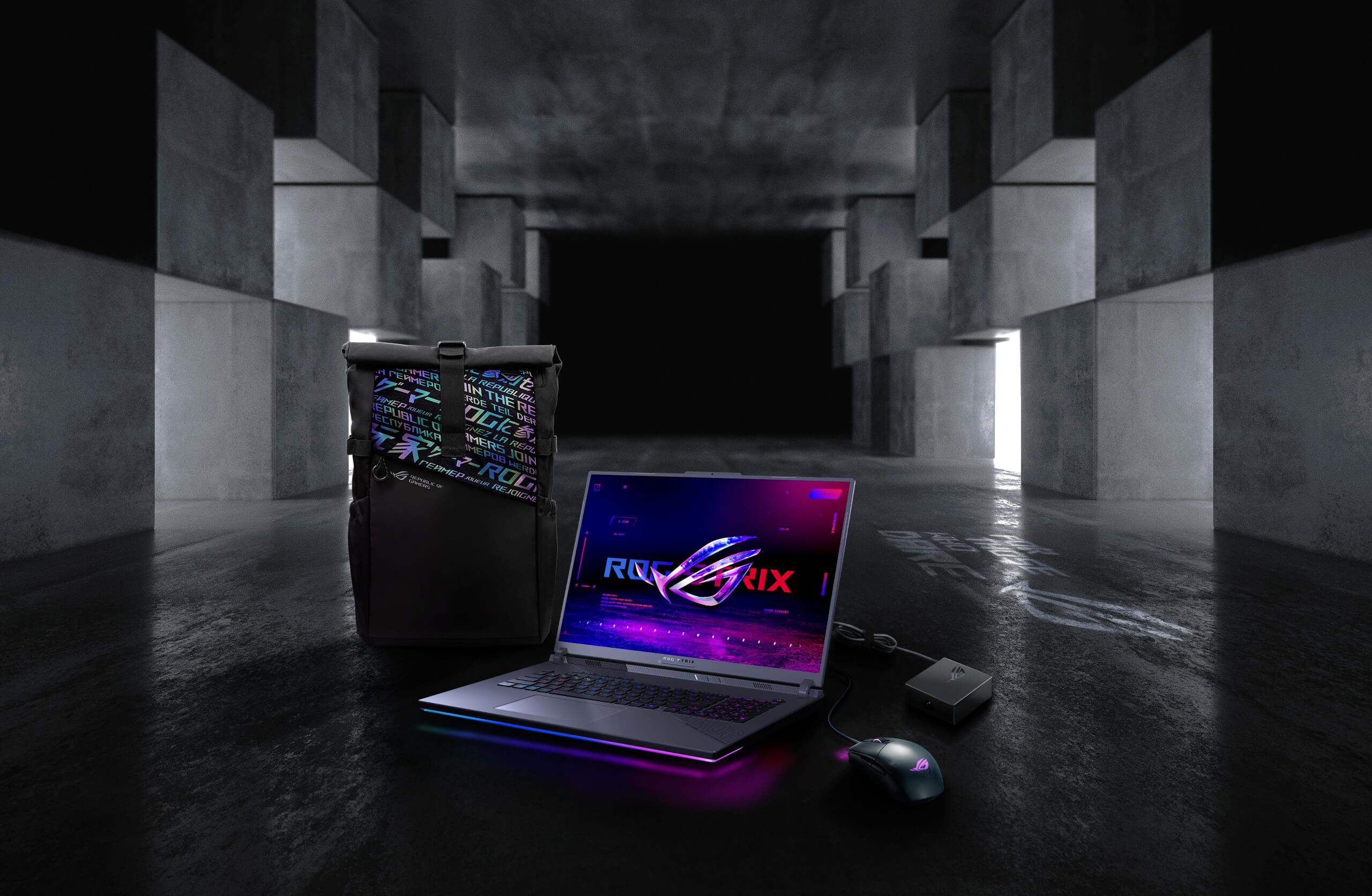 In an underground big space, from left to right; an ROG backpack, G18, ROG Strix Gladius III mouse, and 100W adapter.