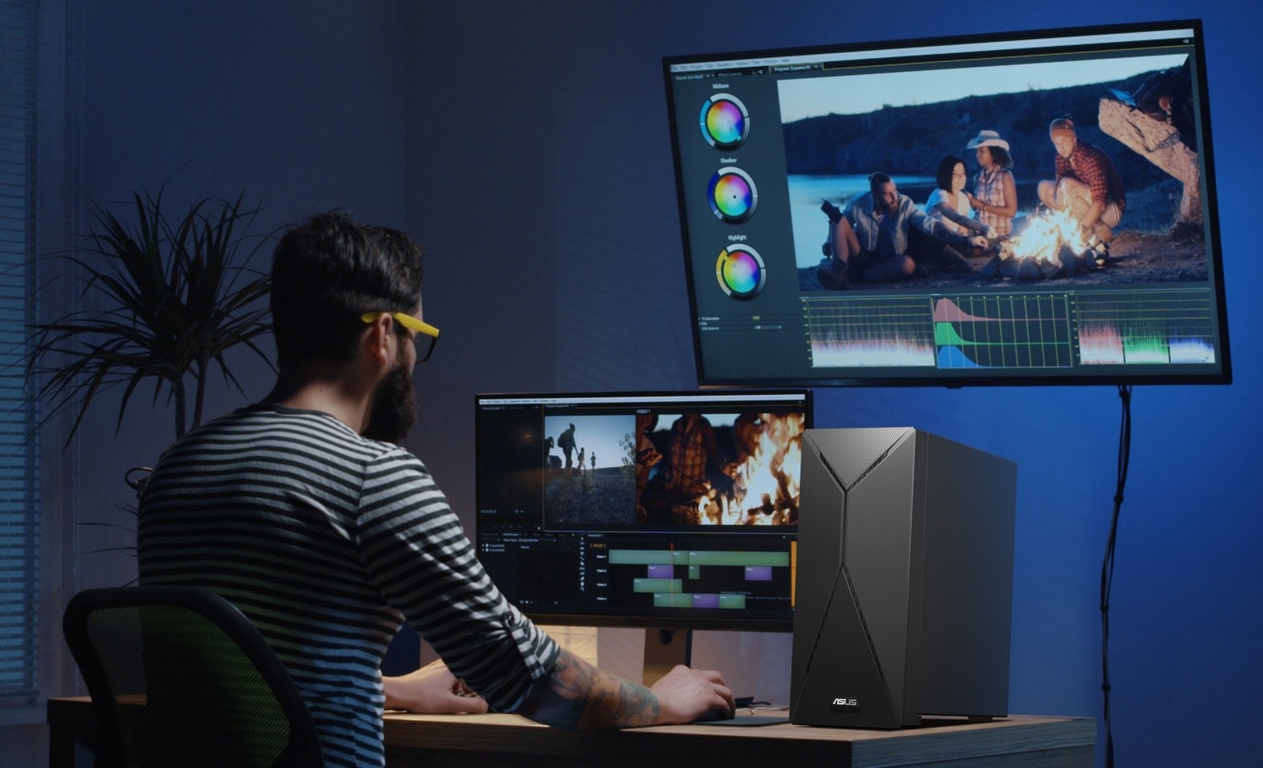 A man editing and color grading video through looking at the monitors that are power by an ASUS S501MER on his right-hand side.