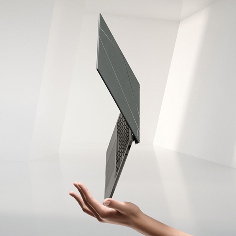 Gray ASUS Zenbook S 13 OLED opened at 120 degrees and is viewed from the right side.