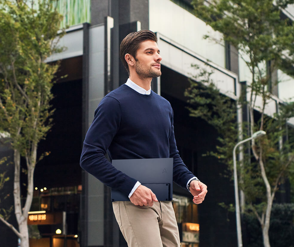 A business man carry the ZenScreen MB17AHG portable monitor walking around