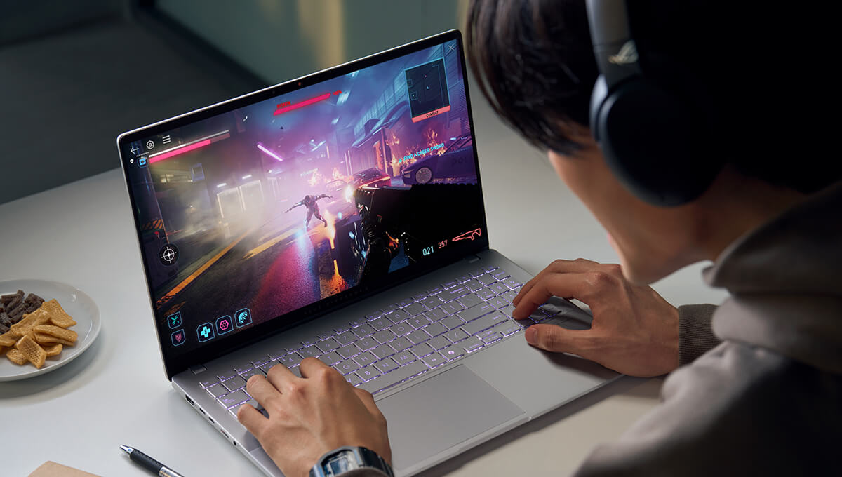 A man wearing headphones is using ASUS Vivobook S 15 to play a game.
