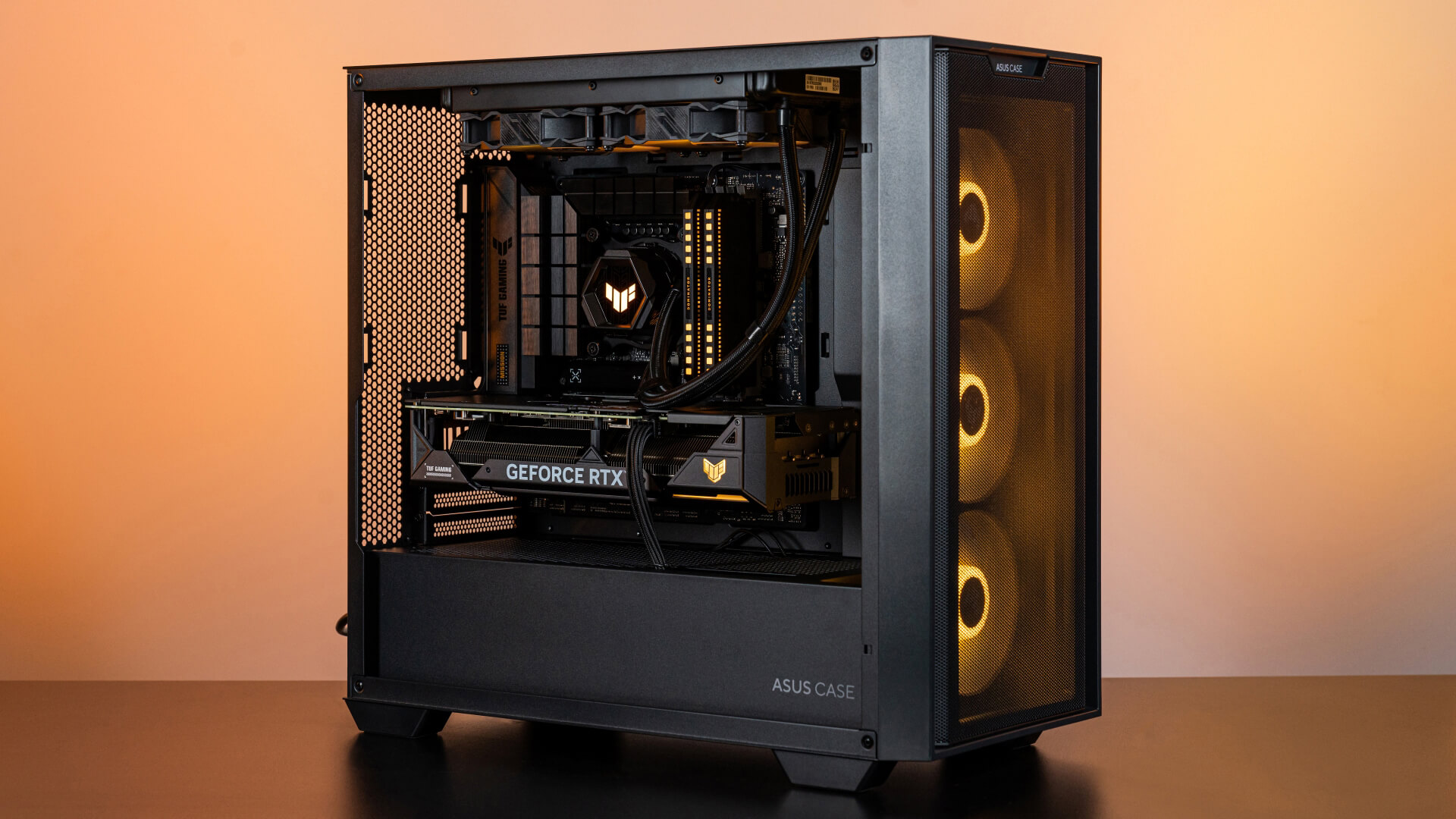 A 45˚ angle of BTF PC build with orange lighting, which shows the VGA’s power cable in the build.