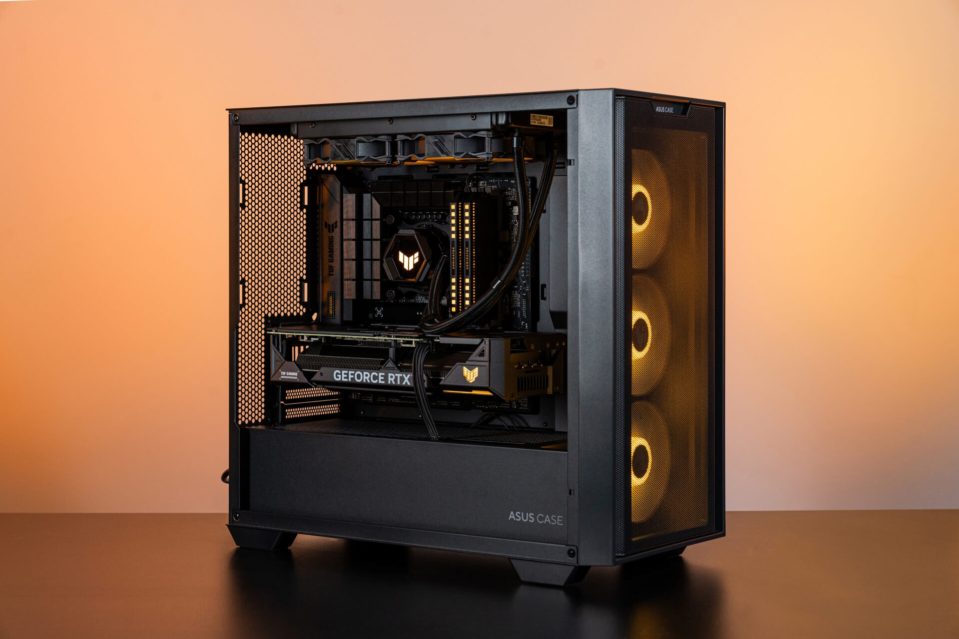 A 45˚ angle of BTF PC build with orange lighting, which shows the VGA’s power cable in the build.