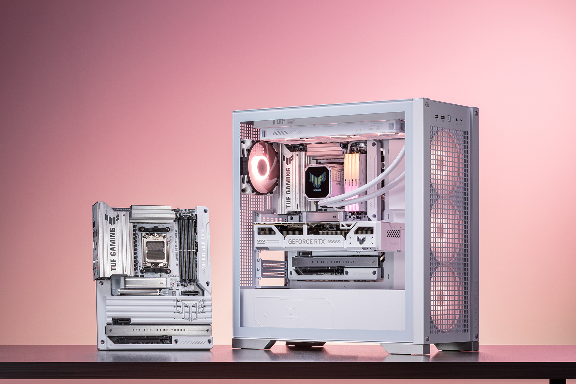 A sleek white TUF GAMING B850-BTF WIFI W motherboard is shown next to a fully built white gaming PC, which also features the same motherboard, both displayed against a pink-to-peach gradient background.
