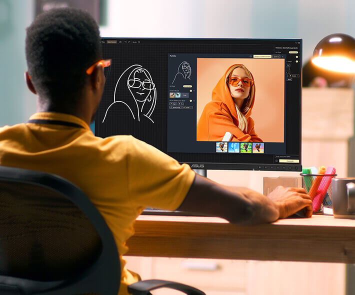 Een persoon in een geel shirt zit aan een bureau met ontwerpsoftware op een ProArt-monitor en maakt een lijntekening van een foto van een vrouw met een oranje hoodie.