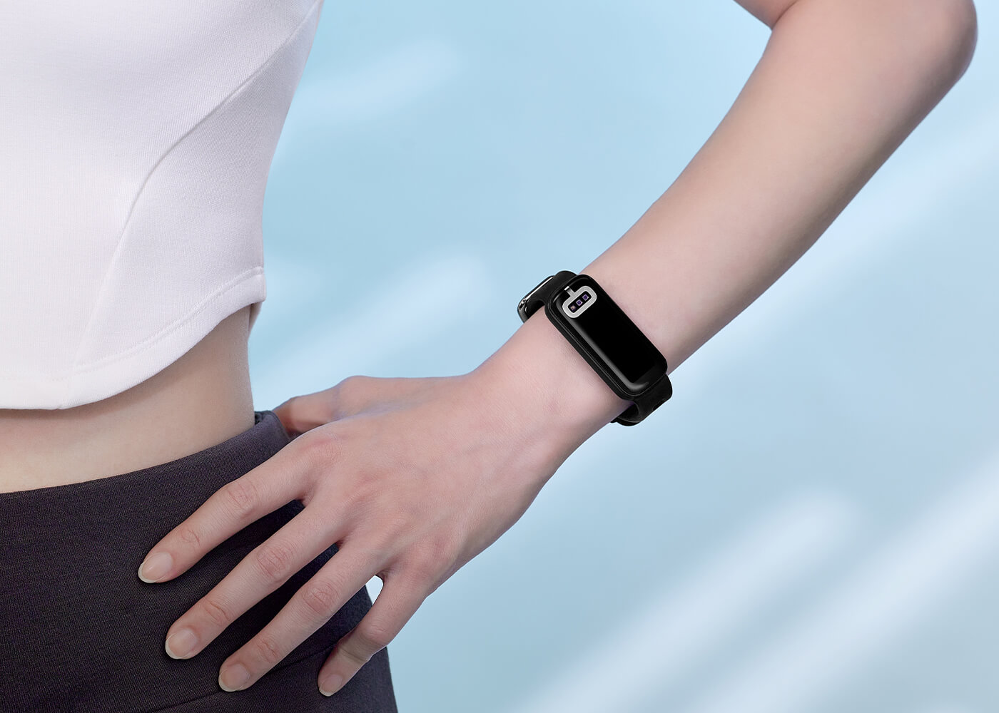 A female is wearing yoga clothes smart band on her wrist for healthy image