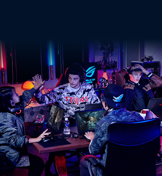 Four young adults are gaming together in a room with ROG equipment.