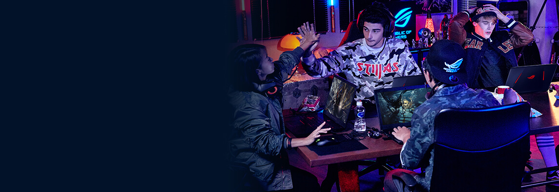 Four young adults are gaming together in a room with ROG equipment.