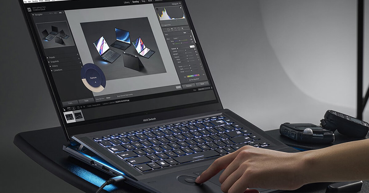A woman’s finger is on the ASUS Dial on a Zenbook Pro 16X OLED, and a photography editing app is displayed onscreen