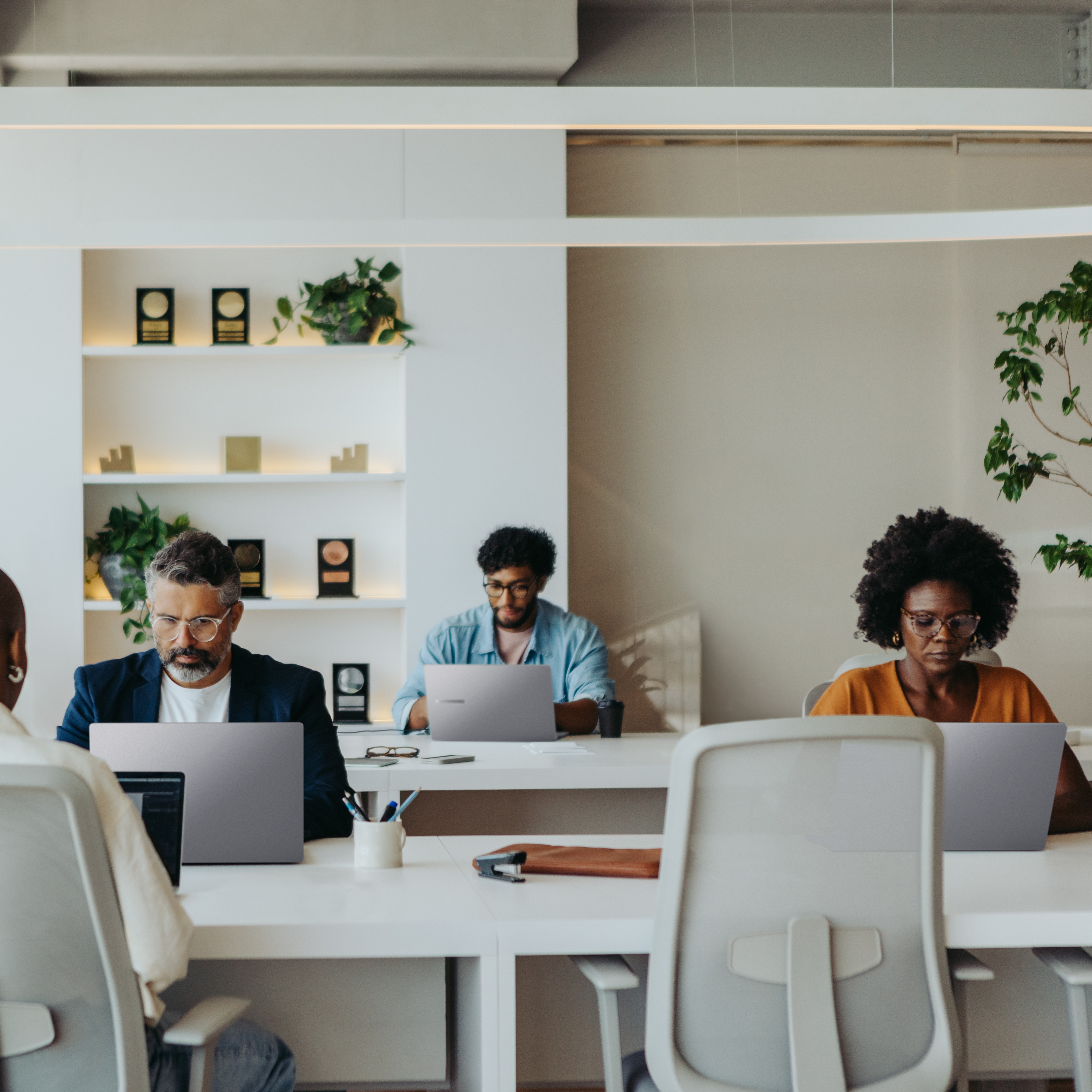 Many office workers working at a co-working space using the Expertbook P series