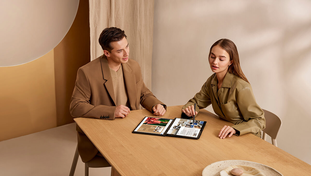 two people using ASUS Zenbook DUO in sharing mode to collaborate on a project