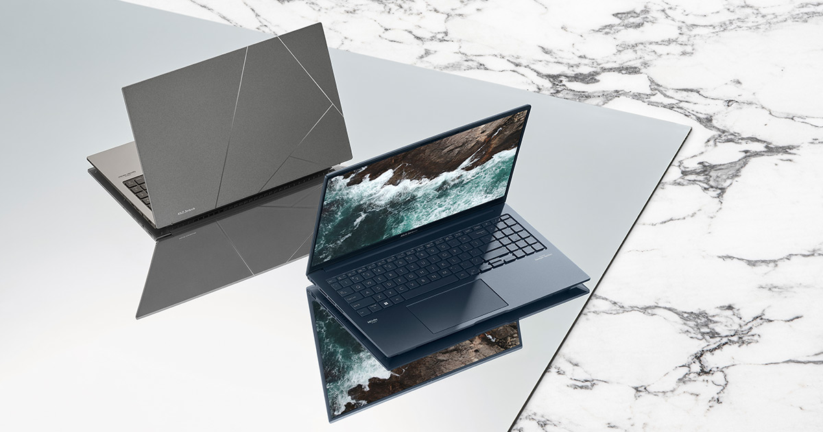 two Zenbook 15 OLED laptops in basalt Gray and Ponder Blue colors with screens open, placed on a reflective surface with on a marble-like background