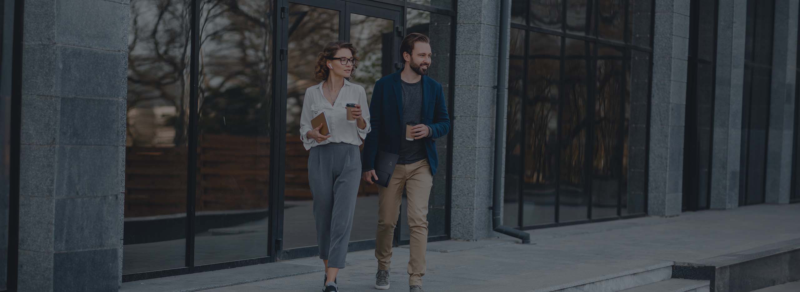 ity scene, with two people heading to work, the man carries the ASUS ZenScreen portable monitor on his left hand effortlessly and holds a drink on his right hand