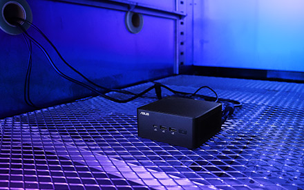  A small black computer box placed on a wire mesh. The whole environment illuminated with a blue hue.