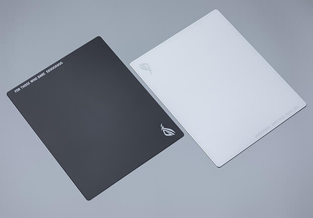 An image with the black and moonlight white Moonstone Ace L mouse pad laid side by side