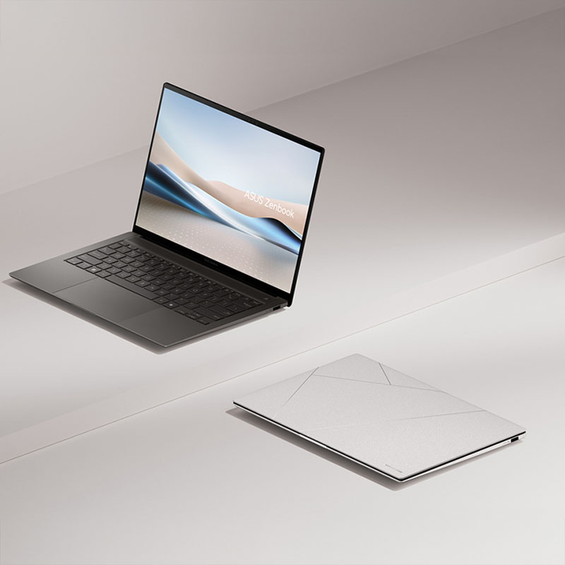 One Zenbook S 14 opened at 100 degrees and viewed from the left front, with another next to it that is closed.