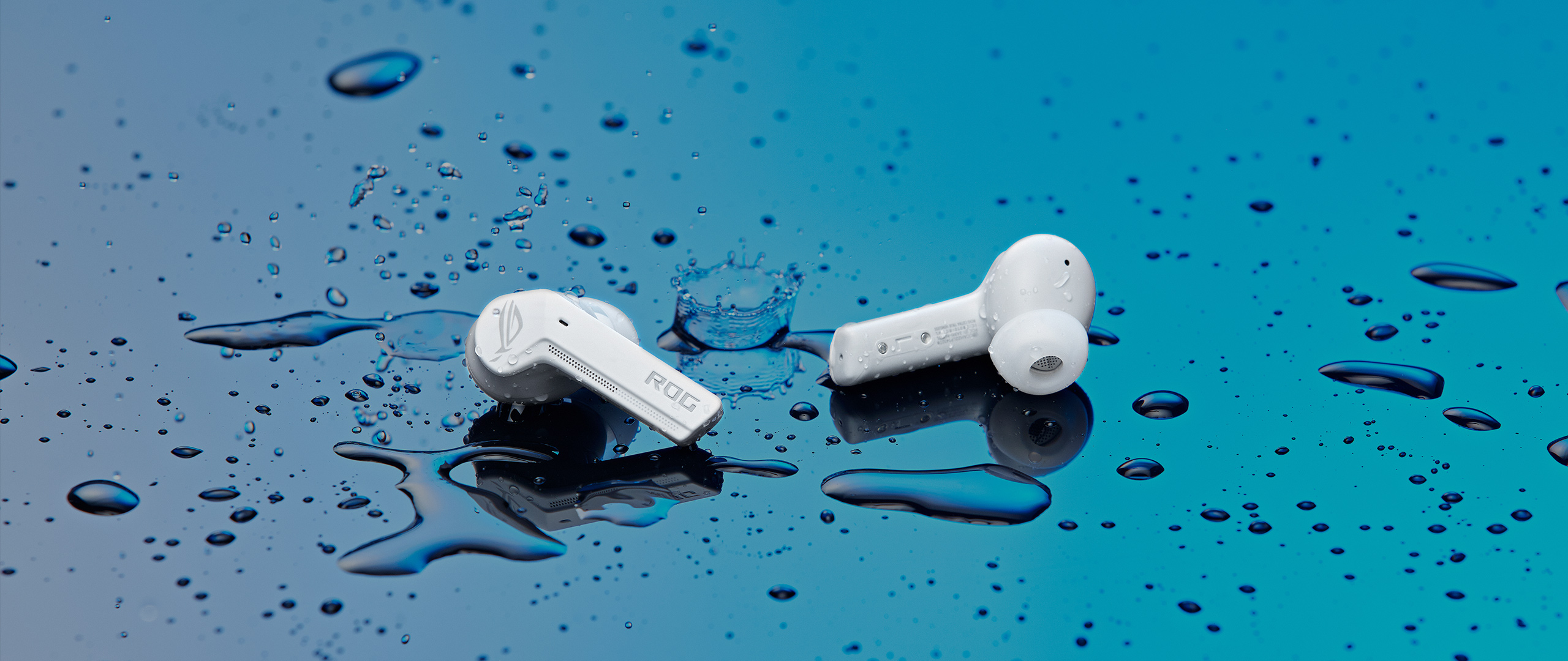 The ROG Cetra True Wireless Earbuds are lying in a puddle of water to demonstrate water resistance