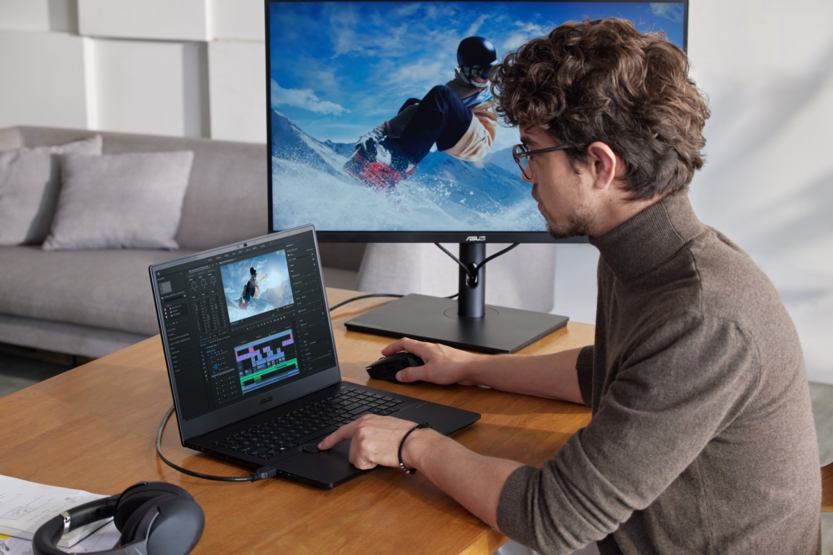 young content creator is editing a snowboarding video with ASUS ProArt Studiobook creator laptop with a 120 Hz display