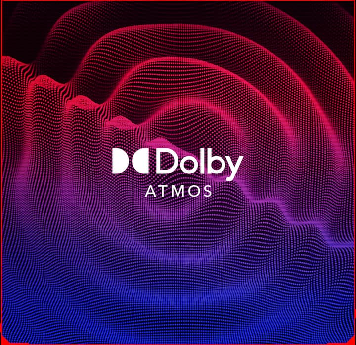 Dolby Atmos logo on screen, surrounded by stylized blue and red sound waves.