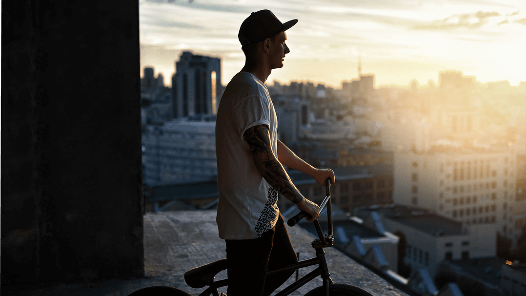 a BMX biker on screen with dim lighting and blurred background.