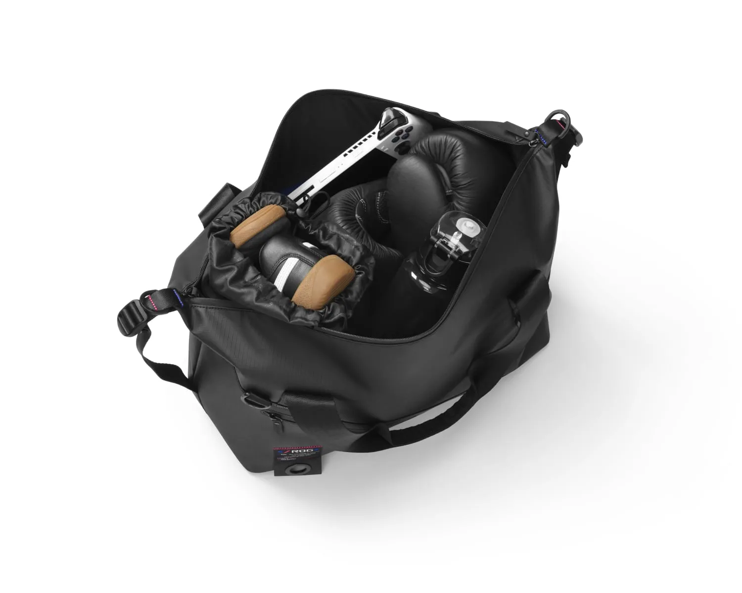 View from above into the main compartment of the ROG SLASH Duffle Bag, with shoes and an ROG Ally clearly visible
