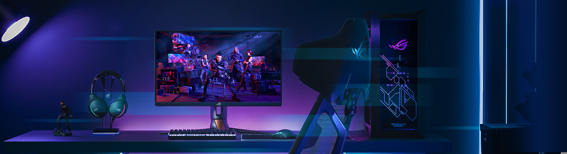 the ROG esports gaming monitor within a complete gaming setup with blue and purple backliight coming from behind