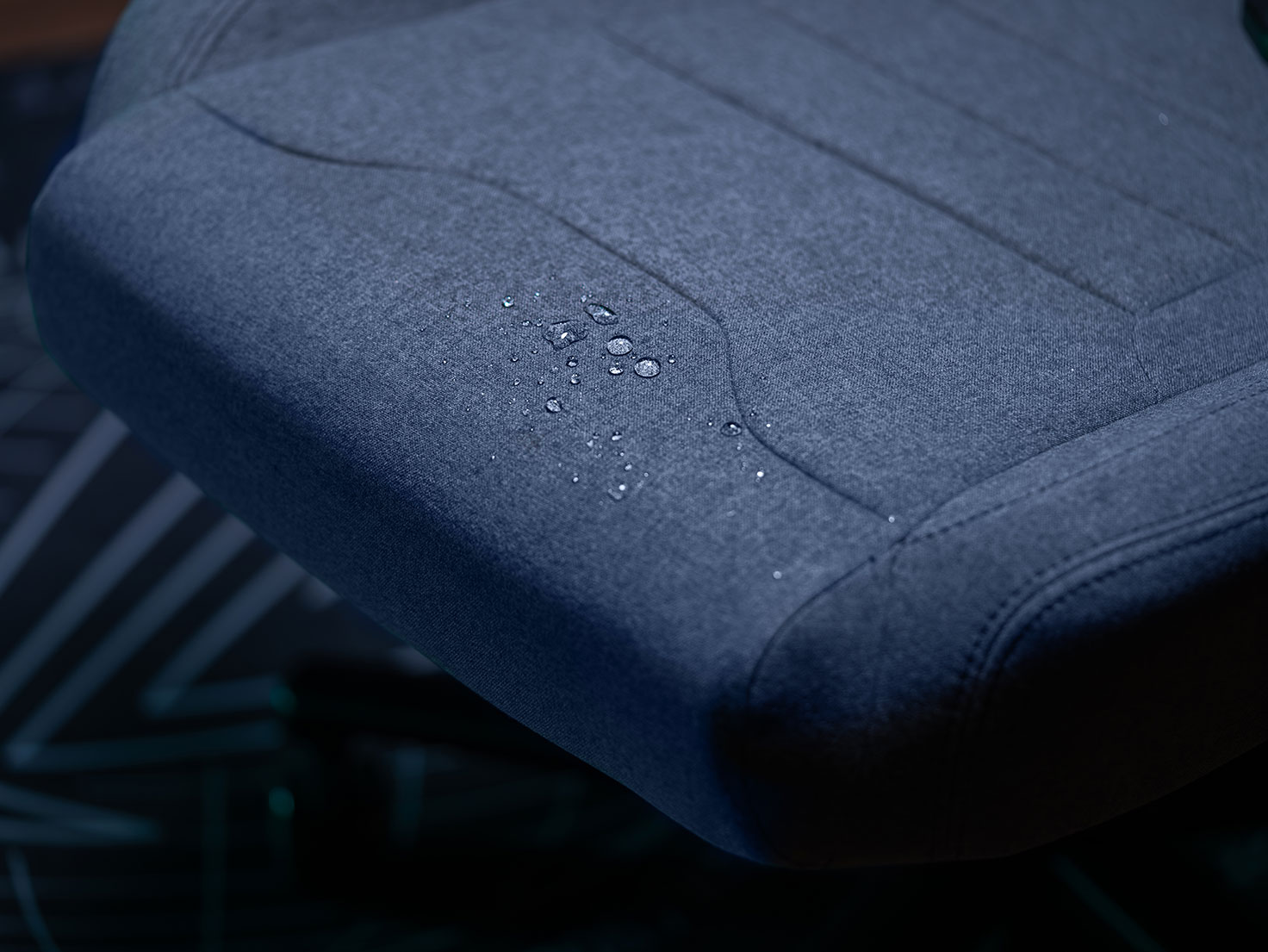 The water droplets on the fabric showcase its water-repellent feature