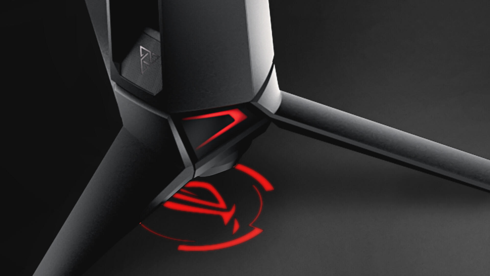 Product photo showing the projected ROG logo on the underside of the monitor stand.