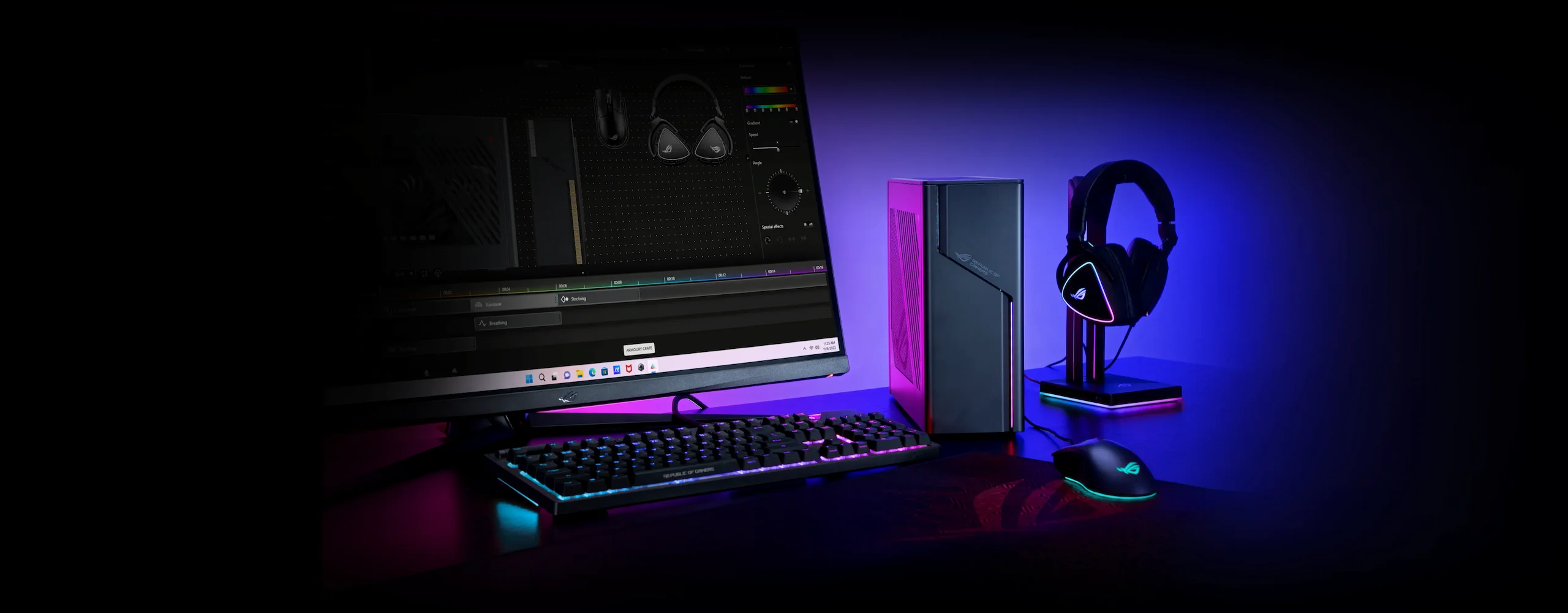 The ROG G22 sitting on a desk next to a gaming monitor, keyboard, mouse, and headset.