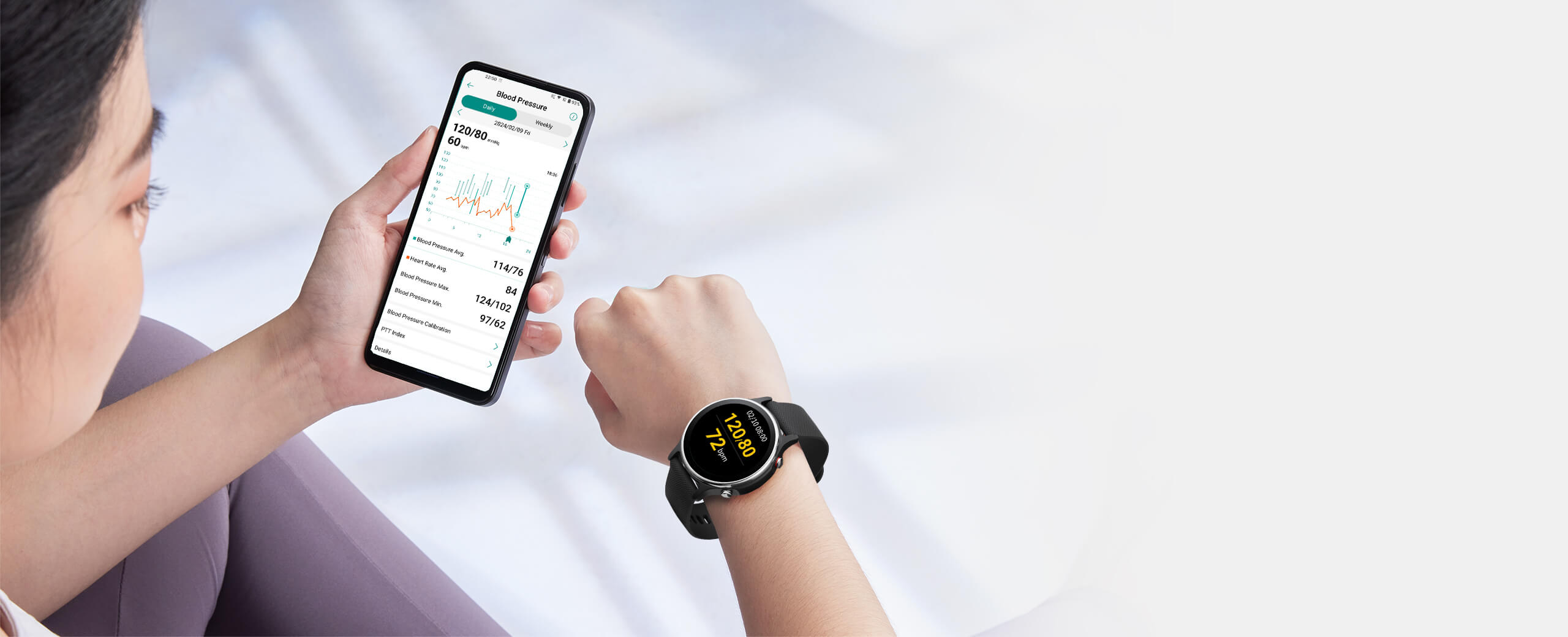 A female is looking at smart watch and blood pressure statitics on her smart phone