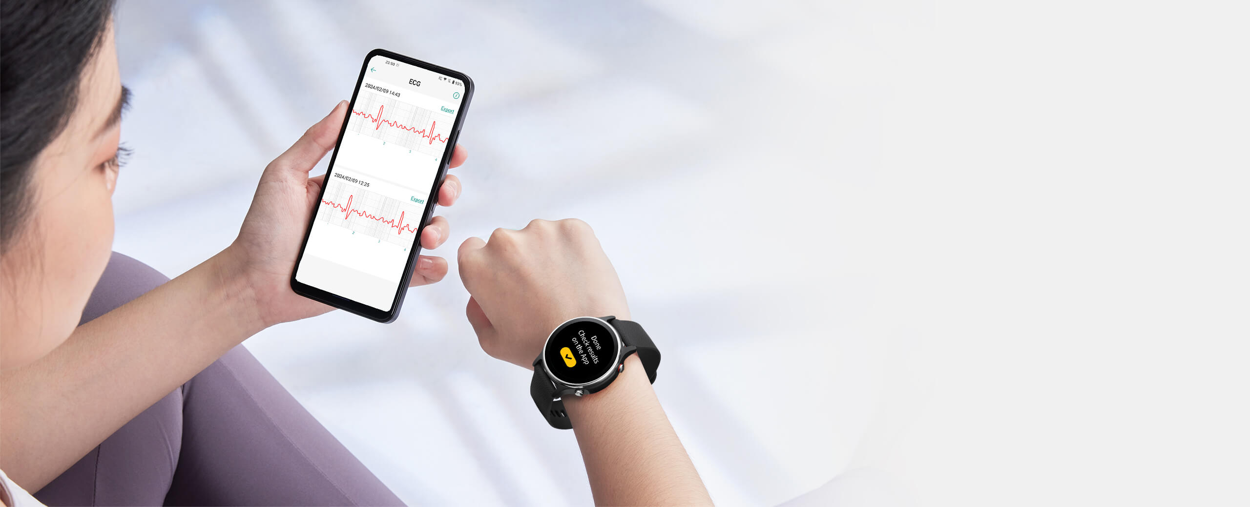 A female is looking at smart watch and electrocardiogram statitics on her smart phone