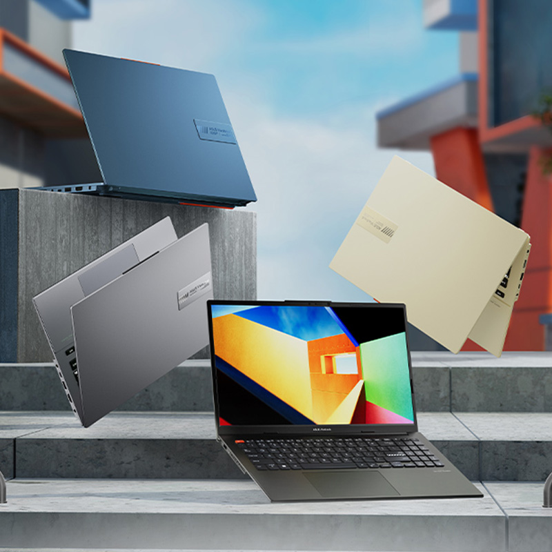Four ASUS Vivobook S 15 OLE laptops in Midnight Black, Solar Blue, Cool Silver, and Cream White Colors in urban setting