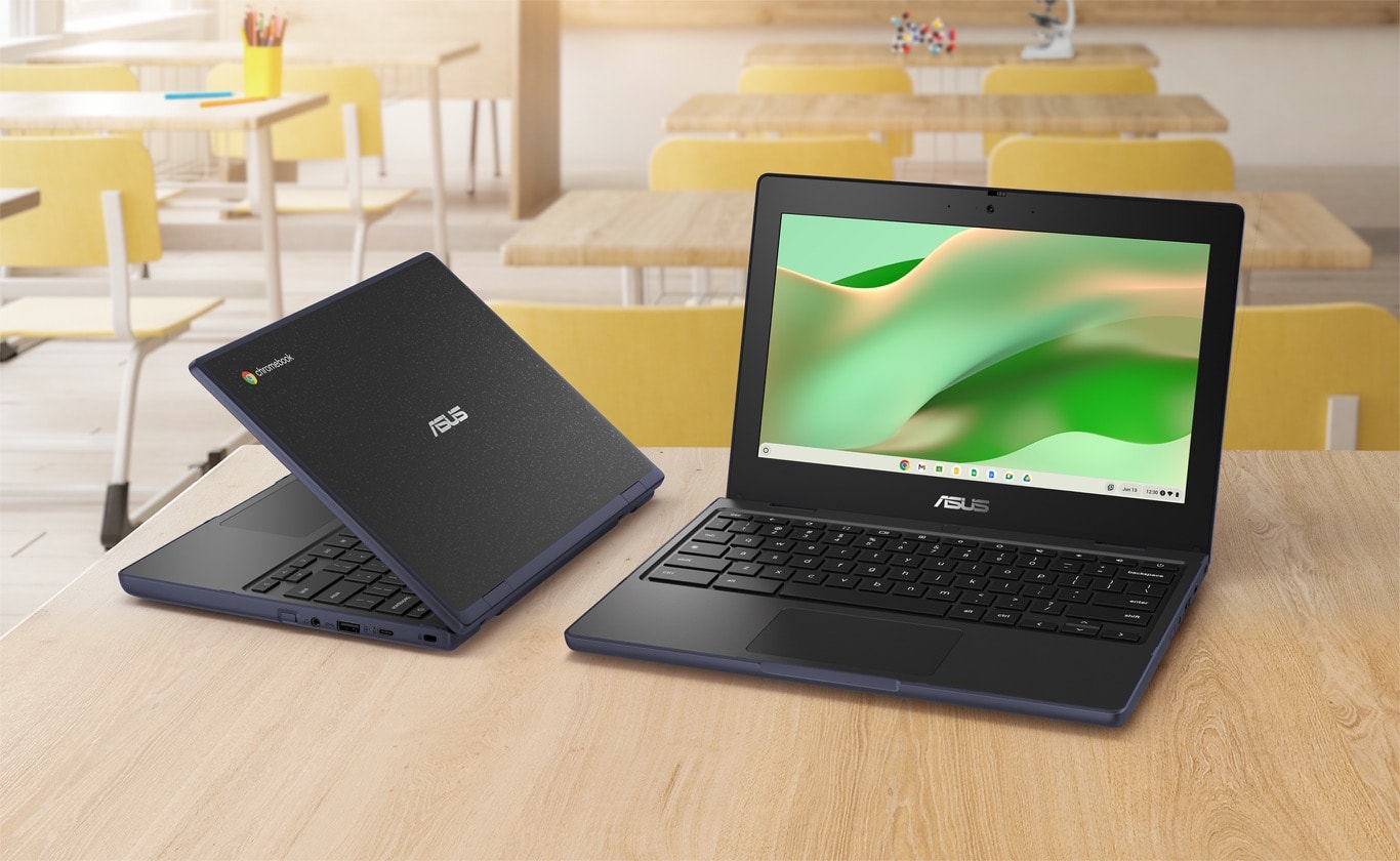 Two ASUS Chromebook CR11 are on the wooden desk with a classroom background, the left side one is an angled rear view showing the chassis. The right one is an angled front view of ASUS Chromebook CR11 in tent mode.