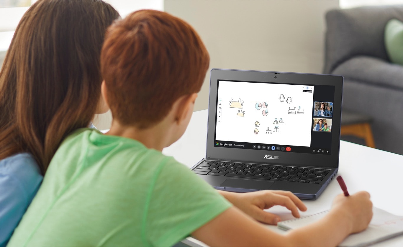 A rear view of child and his mother taking the online class with Google Meet on the ASUS Chromebook CR11 in laptop mode on the desk in front of them.