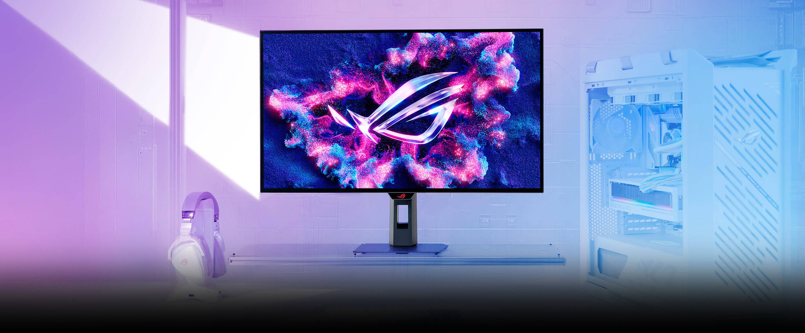 Futuristic desktop setup with ROG OLED monitor displaying vivid pink and blue graphics, surrounded by gaming gear and a white PC case in a purple-lit room. Bold text reads 'One For All' beside the screen.