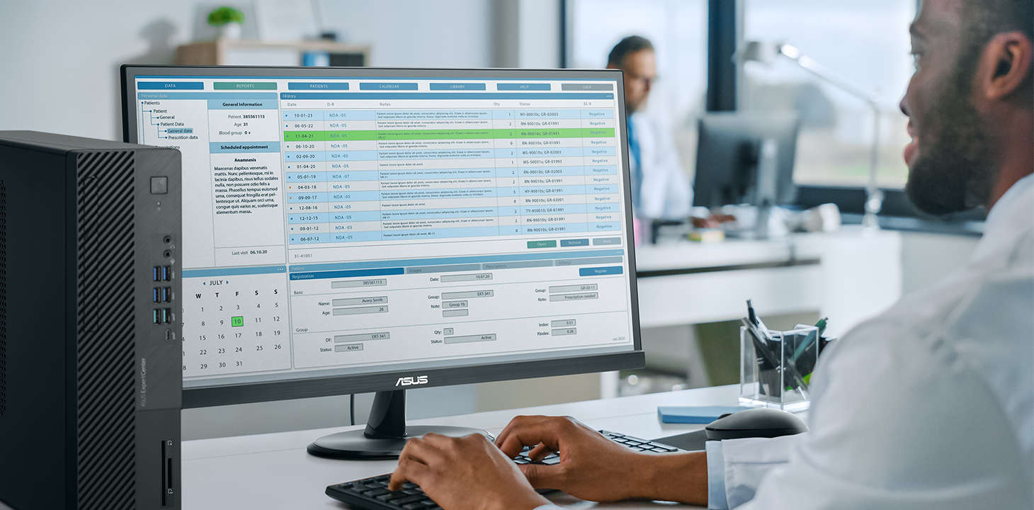 A healthcare worker is working by ASUS ExpertCenter desktop and monitor.