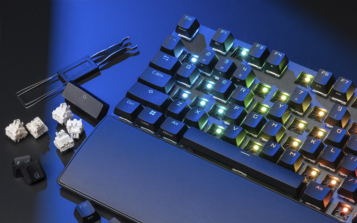ROG Strix Scope II X with many keycaps and switches removed scattered around the keyboard.