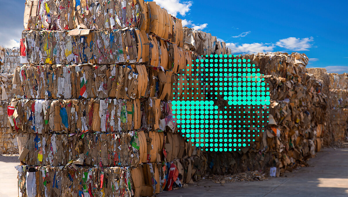 Organized piles of cardboard boxes and recycled paper with a green circle on the right indicating circular economy at ASUS.