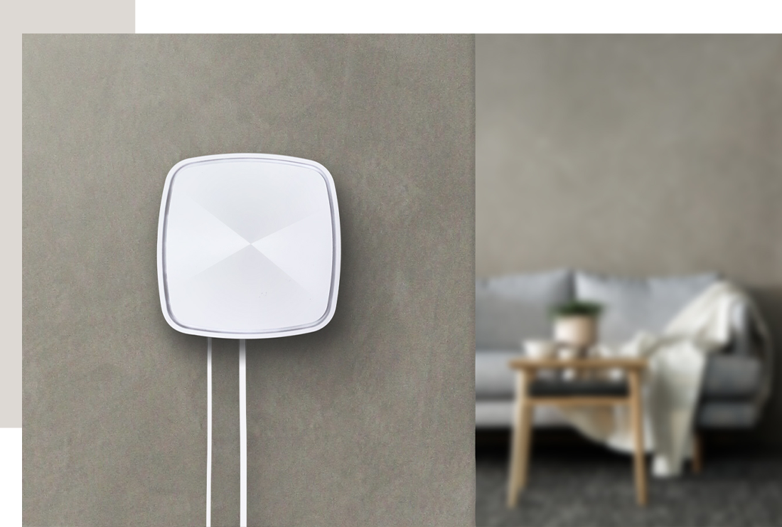 A ZenWiFi  Plus is mounted on the wall.