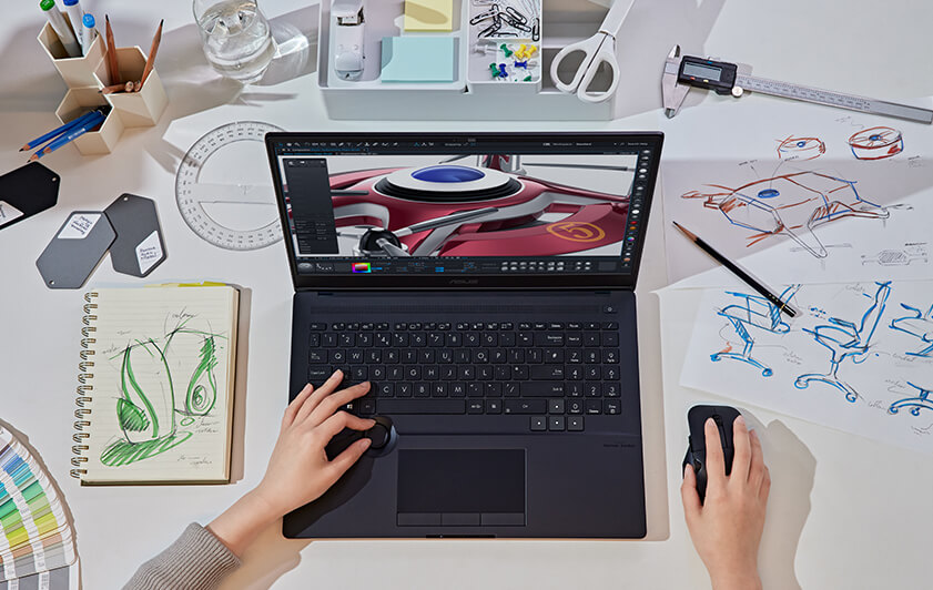 Un designer ajustant la couleur de l'image via le DialPad d'ASUS sur le ProArt Studiobook 16 OLED.