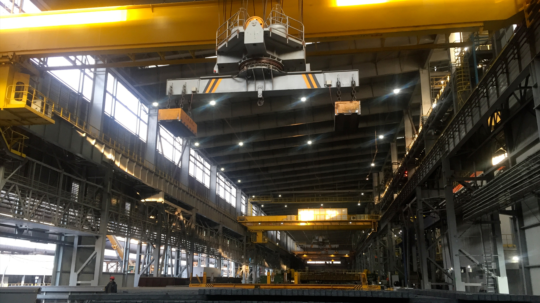 Heavy Industry Crane Operation Heavy-duty crane lifting steel plates and beams in an industrial environment
