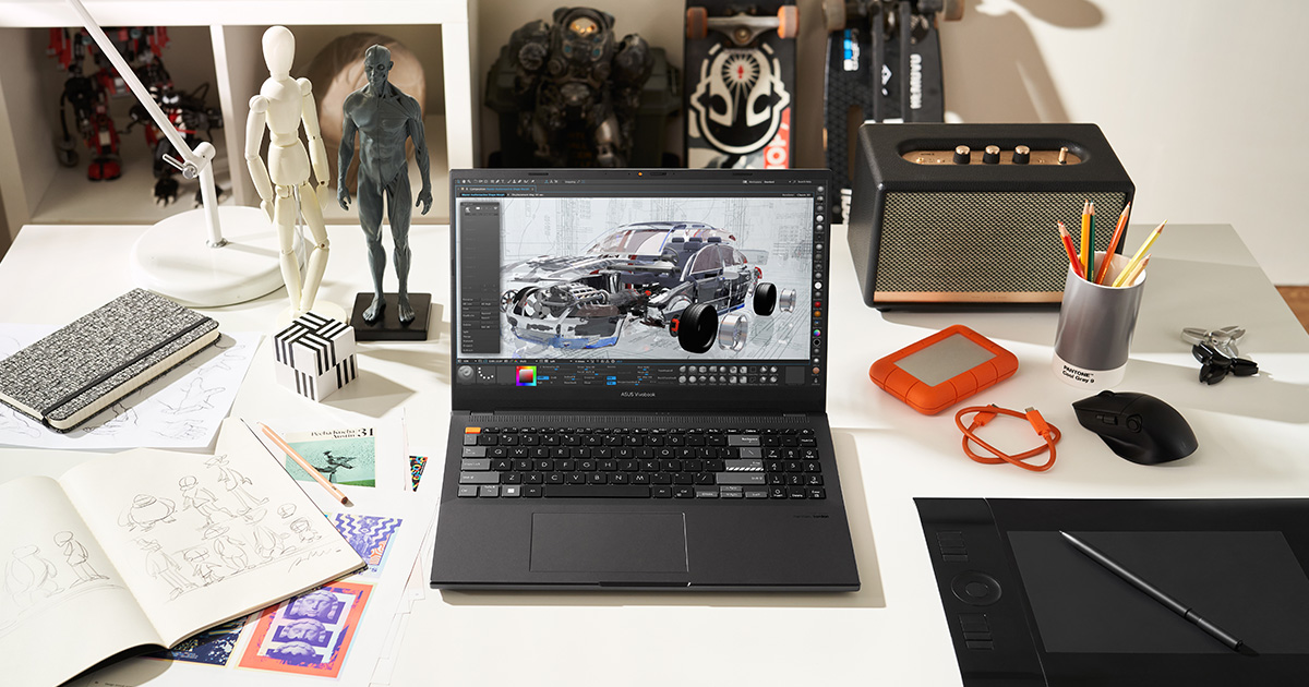 ASUS Vivobook Pro 16X OLED creator laptop with a car design in a creative app on the screen placed on a professional creator desk with other creator tools around