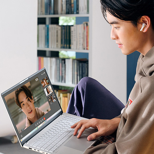 A young man uses ASUS Vivobook S 15 laptop for videoconferencing.