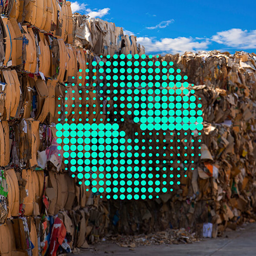 Organized piles of cardboard boxes and recycled paper with a green circle on the right indicating circular economy at ASUS.