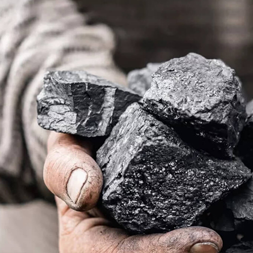 two hands holding a few chunks of ore