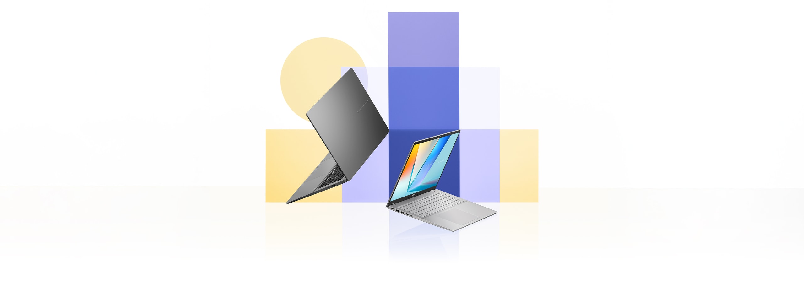 Two open laptops, one grey and one silver, appear angled in front of overlapping blue and yellow rectangular and circular shapes.