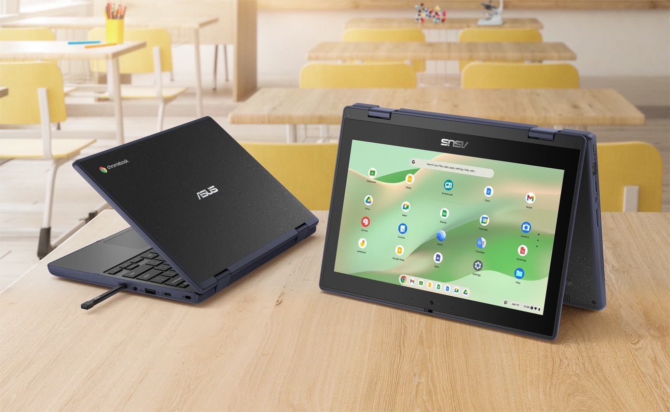 Two ASUS Chromebook CR11 Flip are on the wooden desk with a classroom background, the left side one is an angled rear view showing the chassis. The right one is an angled front view of ASUS Chromebook CR11 Flip in tent mode.