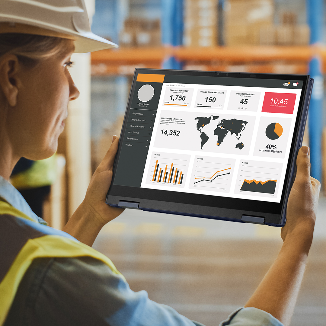 A manufacturing worker is checking information on the ASUS ExpertBook in tablet mode at a warehouse.